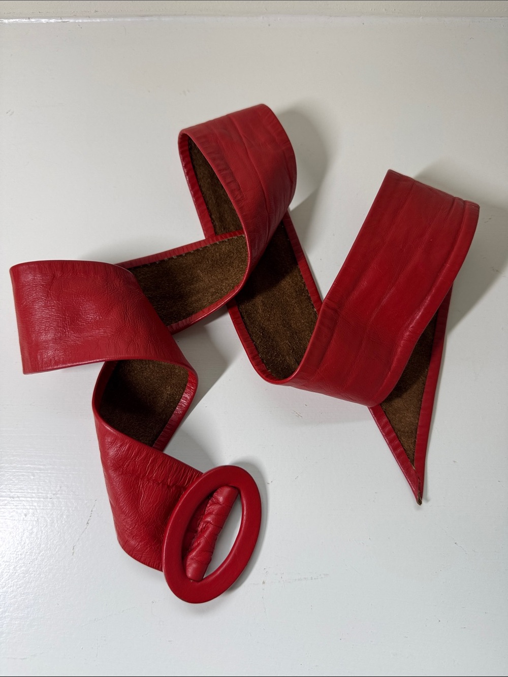 Unbranded Red leather belt with leather covered buckle.